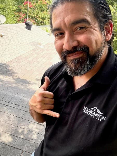 Carlos Trevino working professionally on roof installation